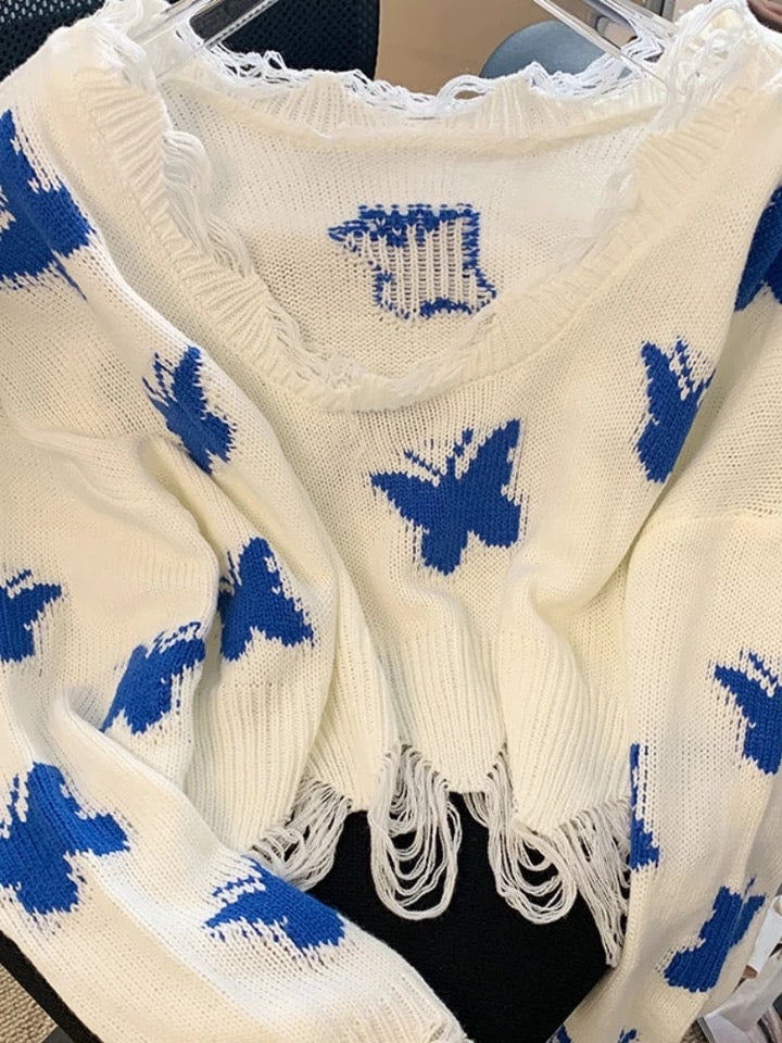 Blauer Strickpullover mit Schmetterlingen